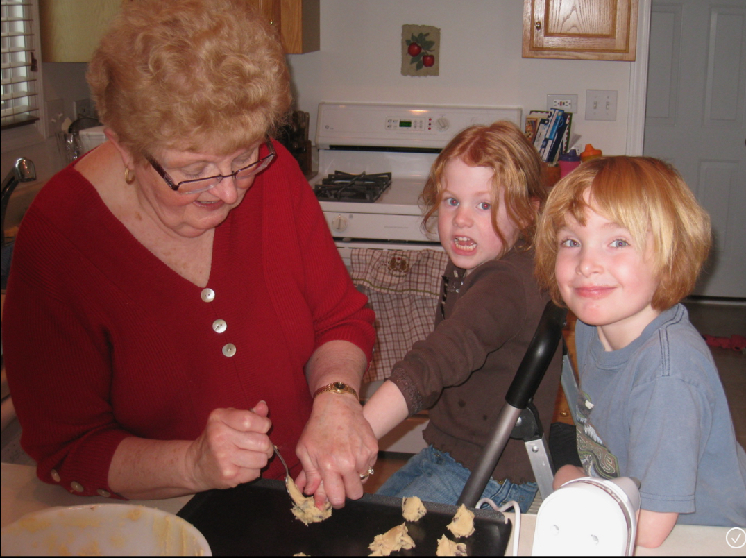 Elizabeth as a child baking cookies alongside her grandma